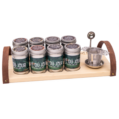 Presentation tea board with cans of tea, teaspoon and tea filter